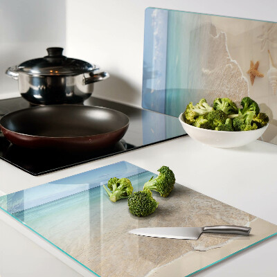 Snijplanken glas Strand met schelpen en golven