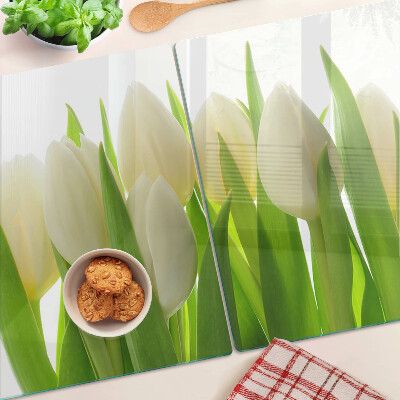 Glazen snijplanken Tulpen tegen een achtergrond van groene bladeren