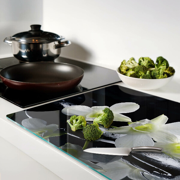 Snijplanken van glas Orchideeën op een zwarte achtergrond