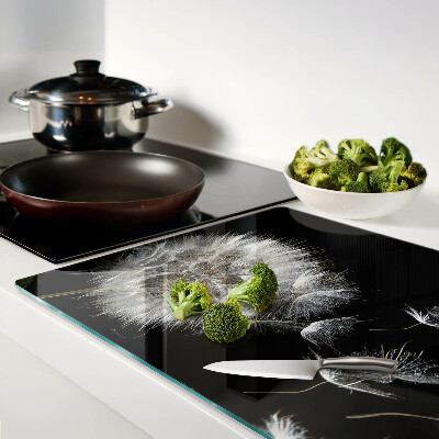 Glazen snijplanken Paardenbloemen op een zwarte achtergrond