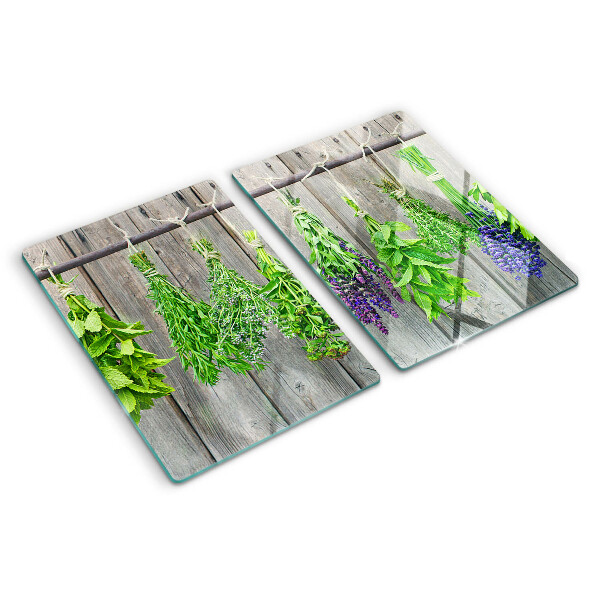 Snijplanken glas Gedroogde kruiden op een houten achtergrond