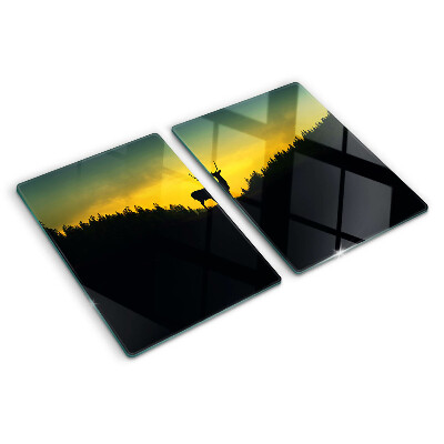 Snijplanken glas Herten tegen de achtergrond van de ondergaande zon.