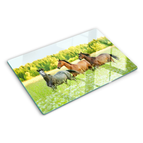 Snijplanken glas Een bijeenkomst van paarden in het veld.