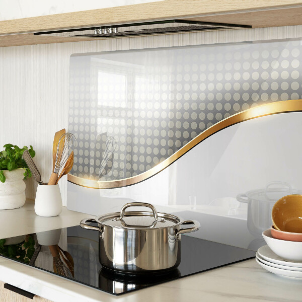 Glazen snijplanken Een gouden golf op een achtergrond van stippen.