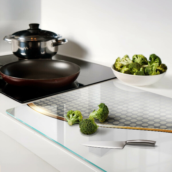 Glazen snijplanken Een gouden golf op een achtergrond van stippen.