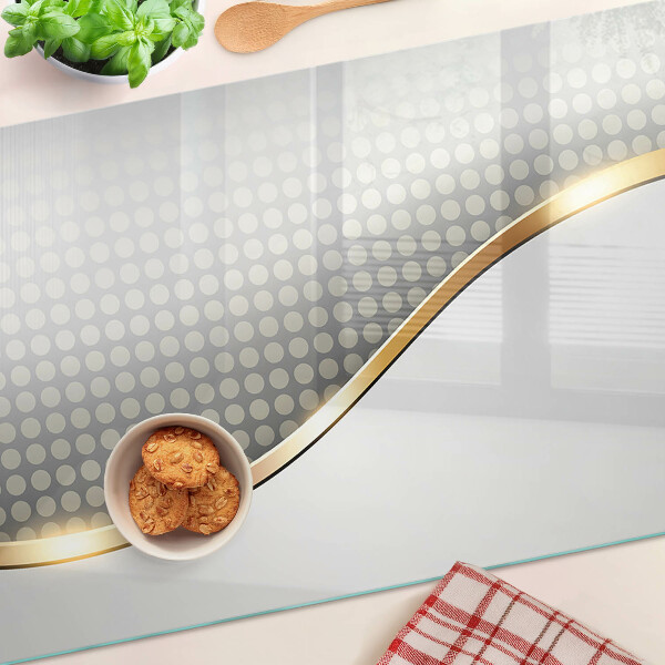 Glazen snijplanken Een gouden golf op een achtergrond van stippen.