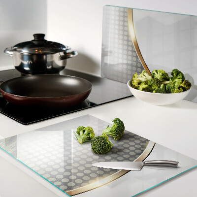 Glazen snijplanken Een gouden golf op een achtergrond van stippen.