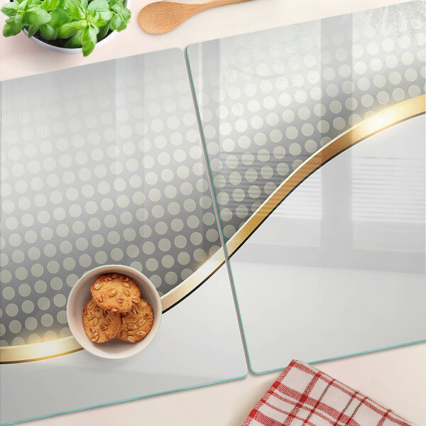 Glazen snijplanken Een gouden golf op een achtergrond van stippen.