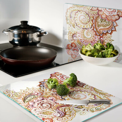 Snijplanken van glas Paisley-motief in tinten rood en goud.