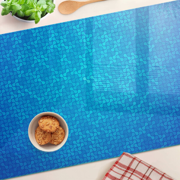 Snijplanken van glas Een golvend patroon in verschillende blauwtinten.