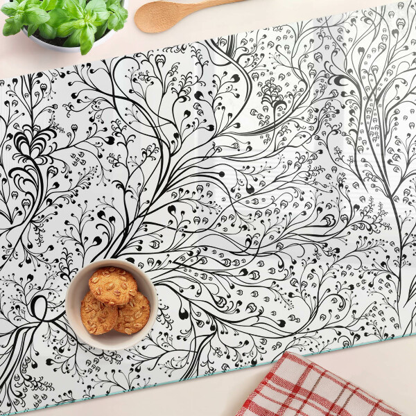 Snijplanken van glas Een plantenpatroon met delicate takken.