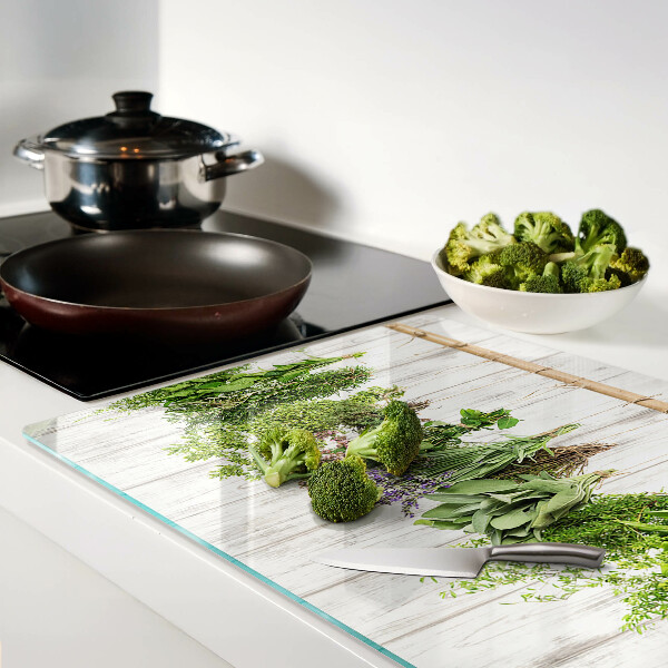 Snijplanken van glas Kruiden op een houten achtergrond