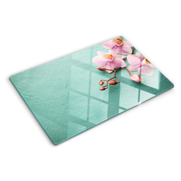 Snijplanken van glas Orchideeën op een blauwe achtergrond