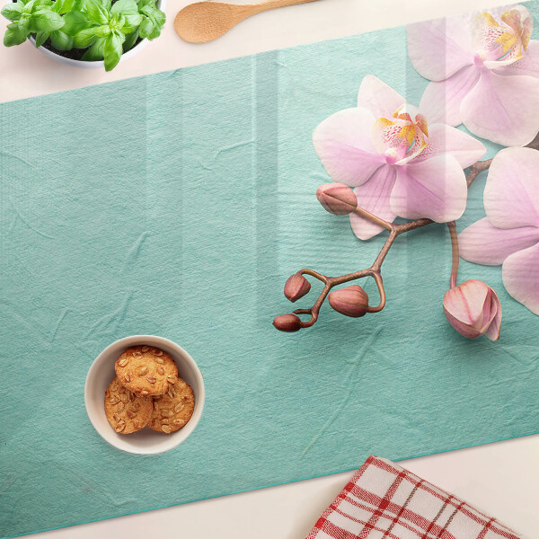 Snijplanken van glas Orchideeën op een blauwe achtergrond