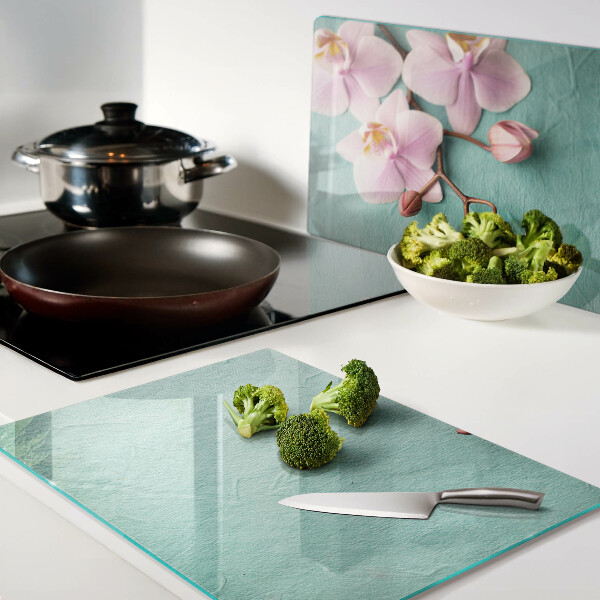 Snijplanken van glas Orchideeën op een blauwe achtergrond