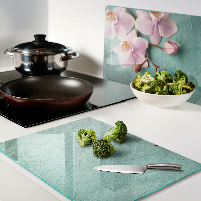 Snijplanken van glas Orchideeën op een blauwe achtergrond