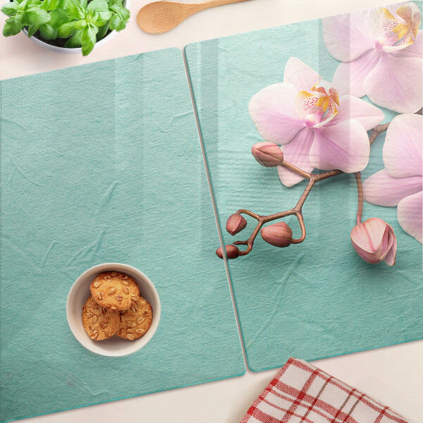 Snijplanken van glas Orchideeën op een blauwe achtergrond