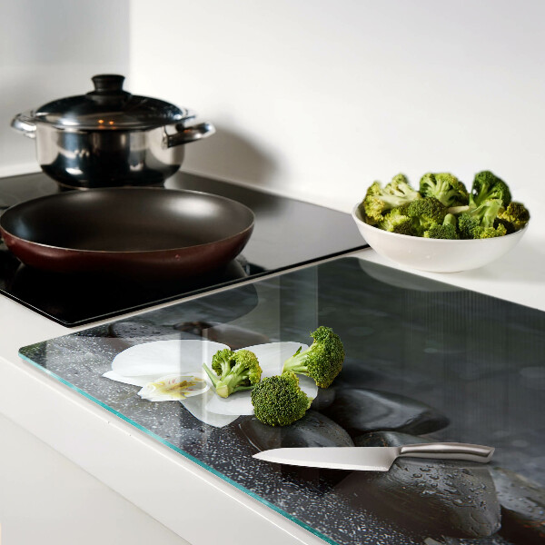 Snijplanken glas Orchideebloem op stenen