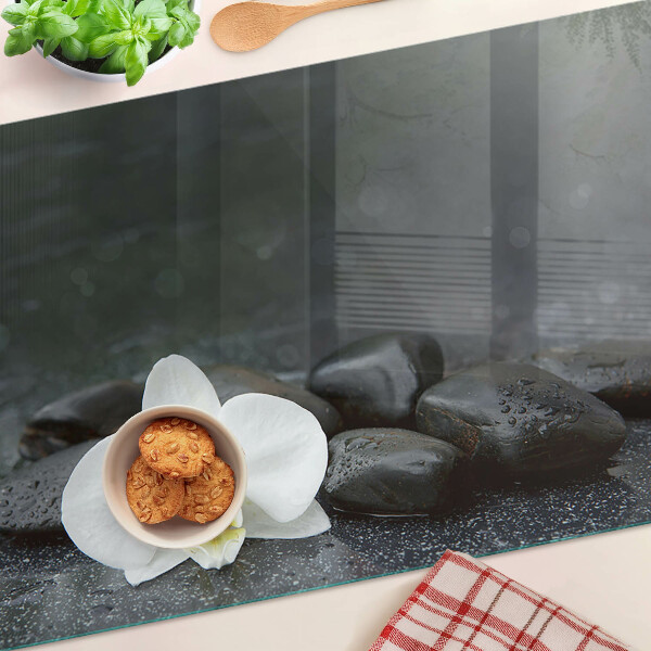 Snijplanken glas Orchideebloem op stenen