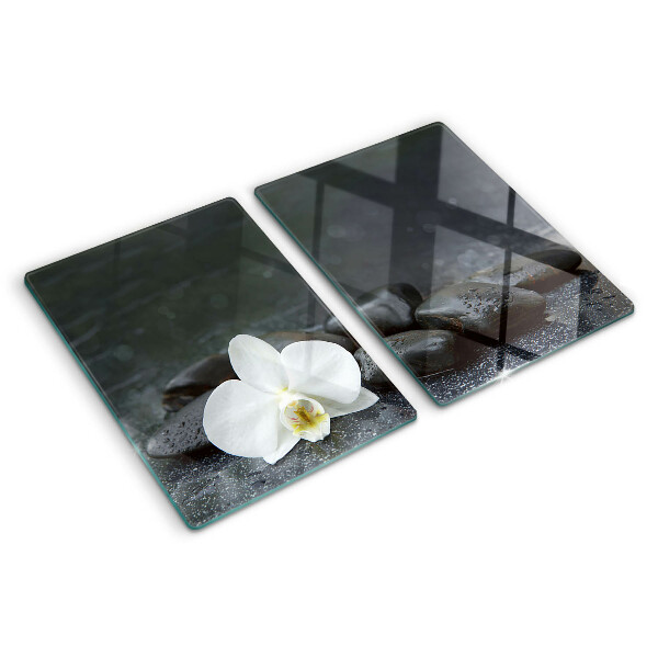 Snijplanken glas Orchideebloem op stenen