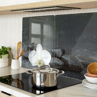 Snijplanken glas Orchideebloem op stenen