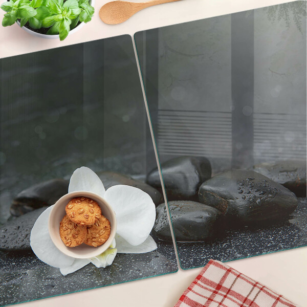 Snijplanken glas Orchideebloem op stenen