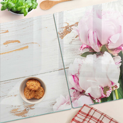 Snijplanken van glas Pioenrozen op een houten achtergrond