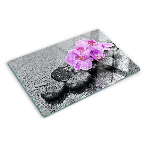 Snijplanken glas Bloemen en stenen tegen een achtergrond van water.