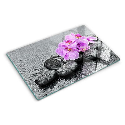 Snijplanken glas Bloemen en stenen tegen een achtergrond van water.