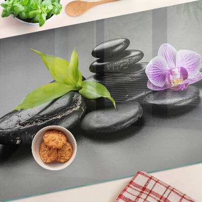 Glazen snijplanken Stenen en orchidee op de achtergrond