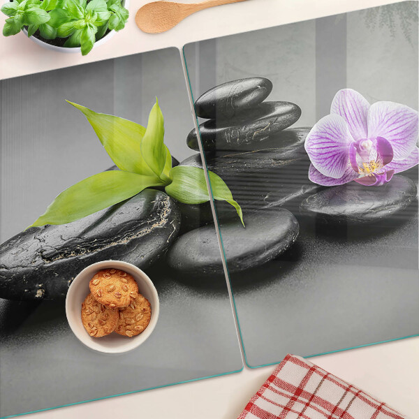 Glazen snijplanken Stenen en orchidee op de achtergrond