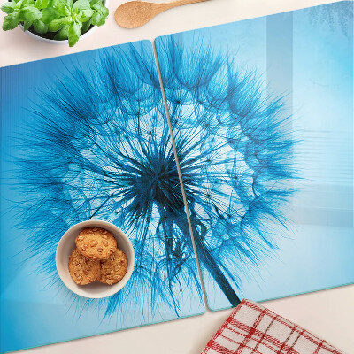 Snijplanken van glas Paardenbloem op een blauwe achtergrond