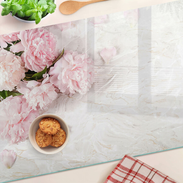 Snijplanken van glas Pioenrozen op een marmeren achtergrond