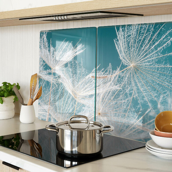 Snijplanken van glas Paardenbloemen op een blauwe achtergrond