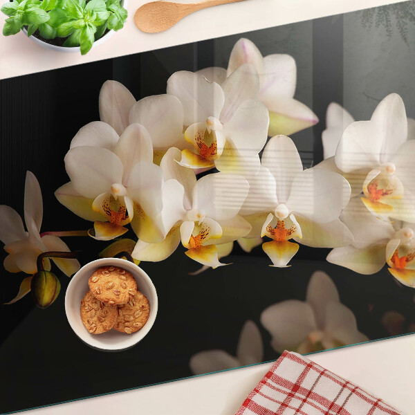 Snijplanken van glas Orchideeën op een zwarte achtergrond