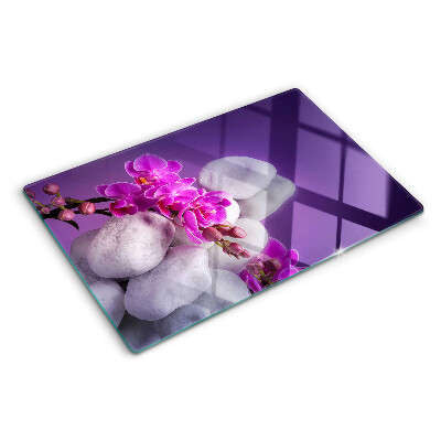 Snijplanken glas Orchideeën op een achtergrond van stenen.