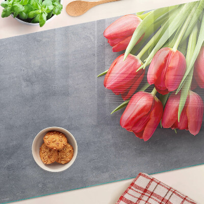 Snijplanken van glas Tulpen op een grijze achtergrond