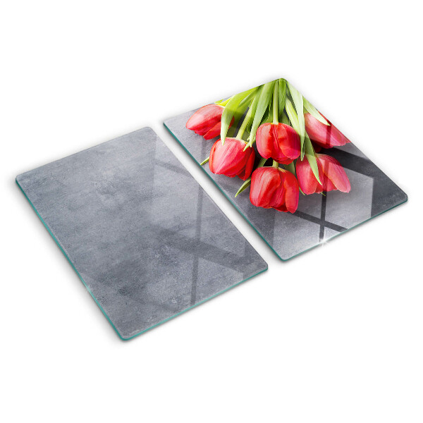 Snijplanken van glas Tulpen op een grijze achtergrond