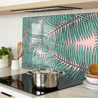 Snijplanken van glas Palmbladeren op een roze achtergrond