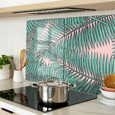 Snijplanken van glas Palmbladeren op een roze achtergrond