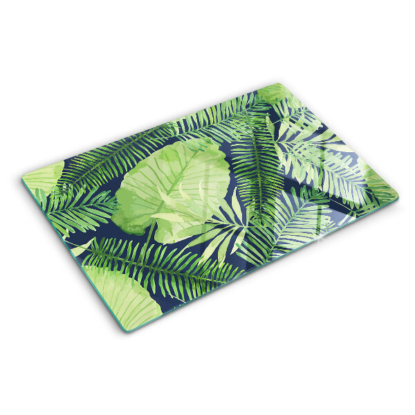 Snijplanken van glas Tropische bladeren op een donkere achtergrond