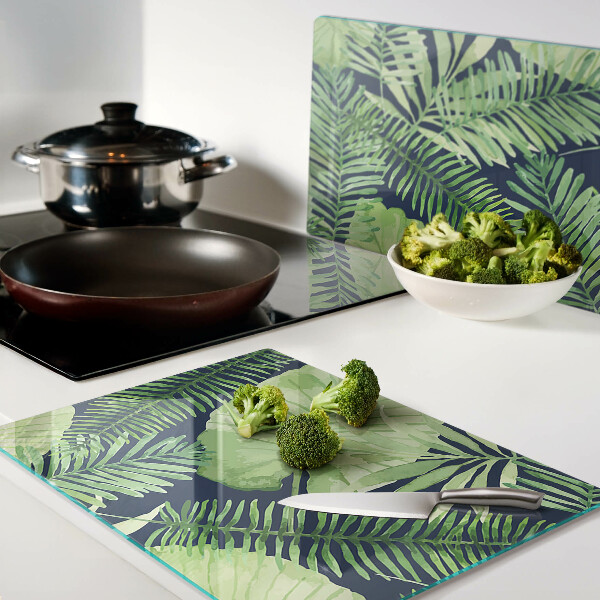 Snijplanken van glas Tropische bladeren op een donkere achtergrond