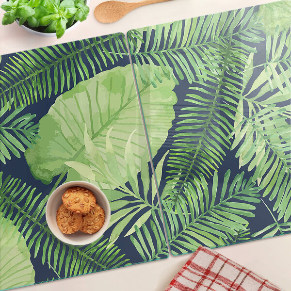 Snijplanken van glas Tropische bladeren op een donkere achtergrond