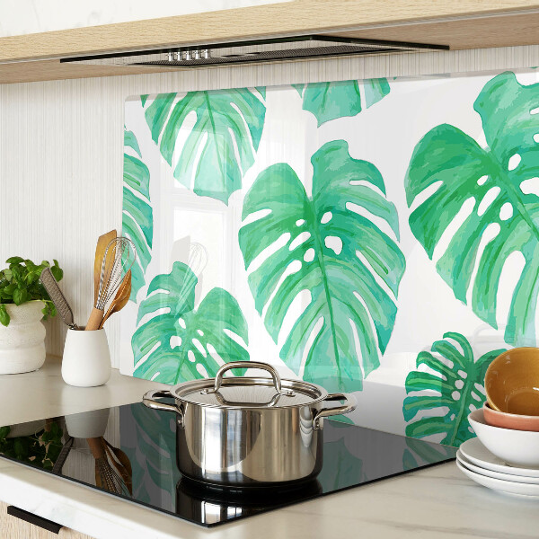 Snijplanken van glas Monstera-bladeren op een witte achtergrond