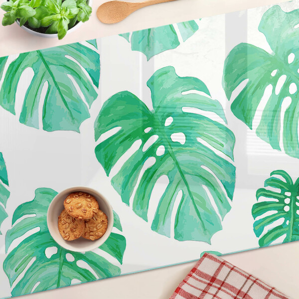 Snijplanken van glas Monstera-bladeren op een witte achtergrond