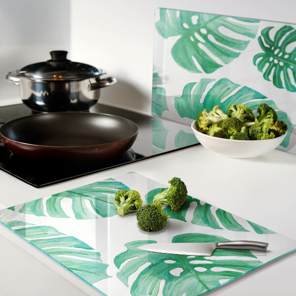 Snijplanken van glas Monstera-bladeren op een witte achtergrond