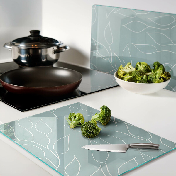 Glazen snijplanken Bladeren op de achtergrond