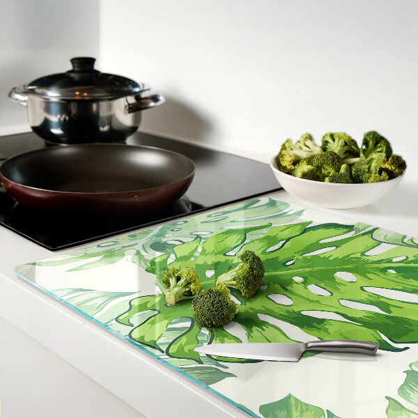 Snijplanken glas Monstera-bladeren op een lichte achtergrond