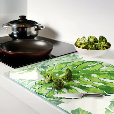 Snijplanken glas Monstera-bladeren op een lichte achtergrond