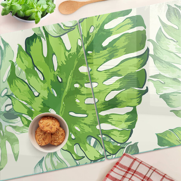 Snijplanken glas Monstera-bladeren op een lichte achtergrond